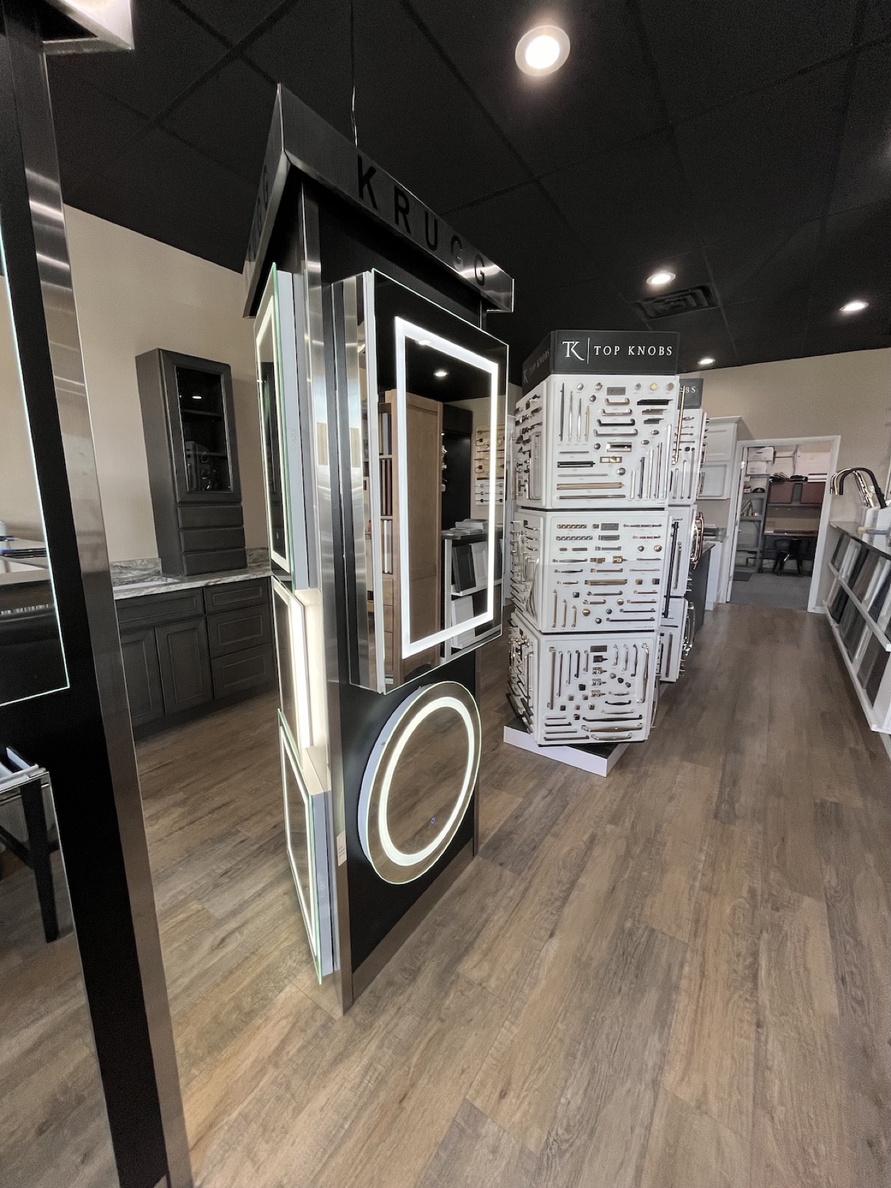 Fortune Shower Doors showroom in Sterling Heights with faucet displays, lighted mirror and Top Knobs hardware