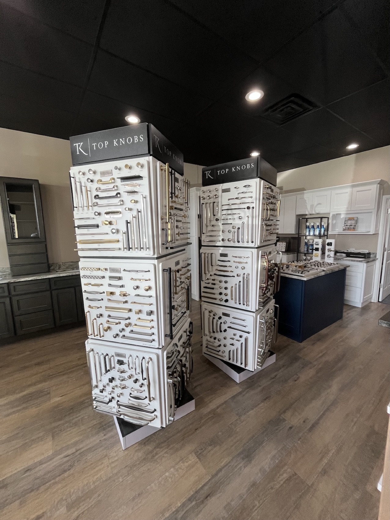 Top Knobs hardware display towers and lighted mirror in the Fortune Shower Doors showroom