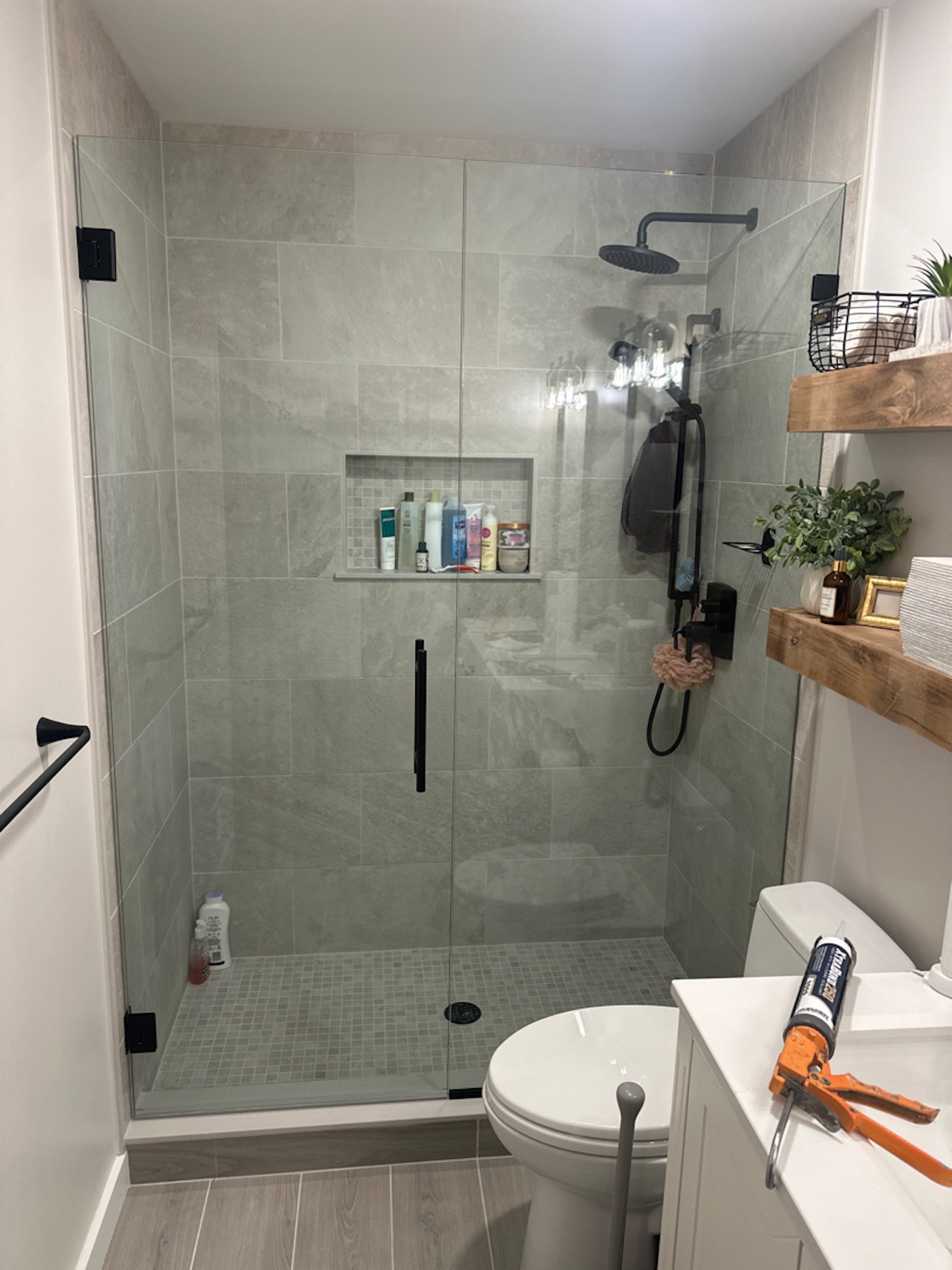 Hinged swing glass shower door with matte black hardware